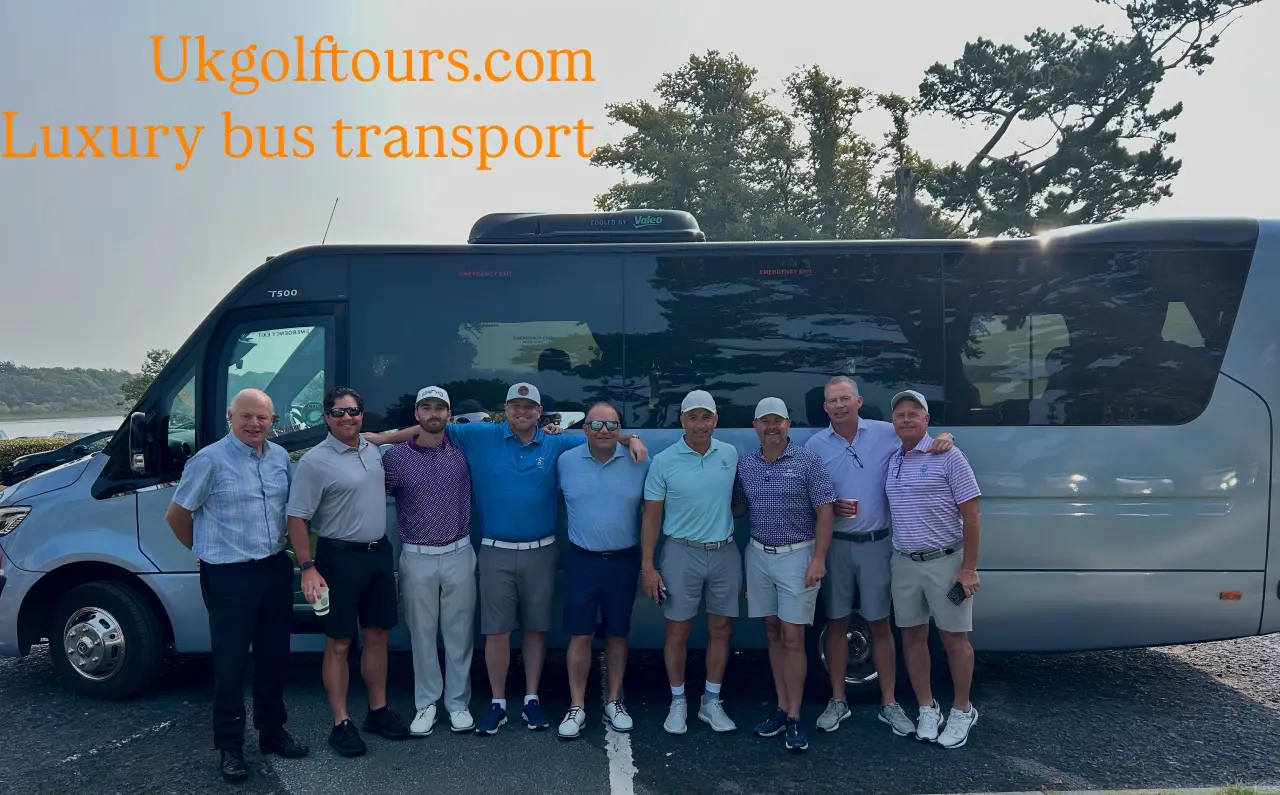 Group posing in front of luxury bus.