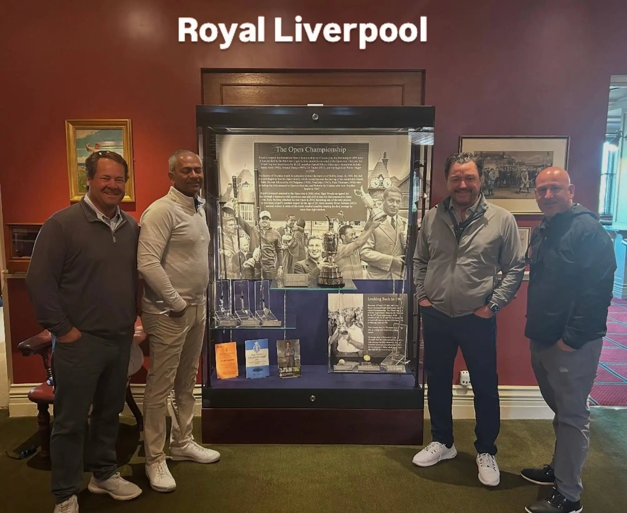 Four men posing at Royal Liverpool exhibit.