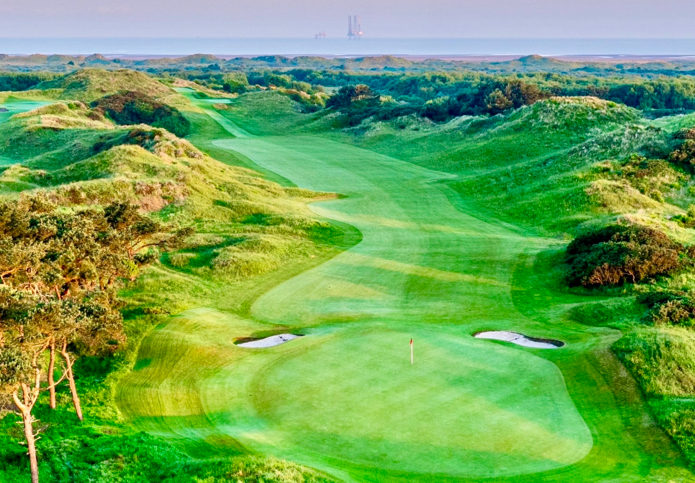 Golf course with lush green fairways and bunkers.