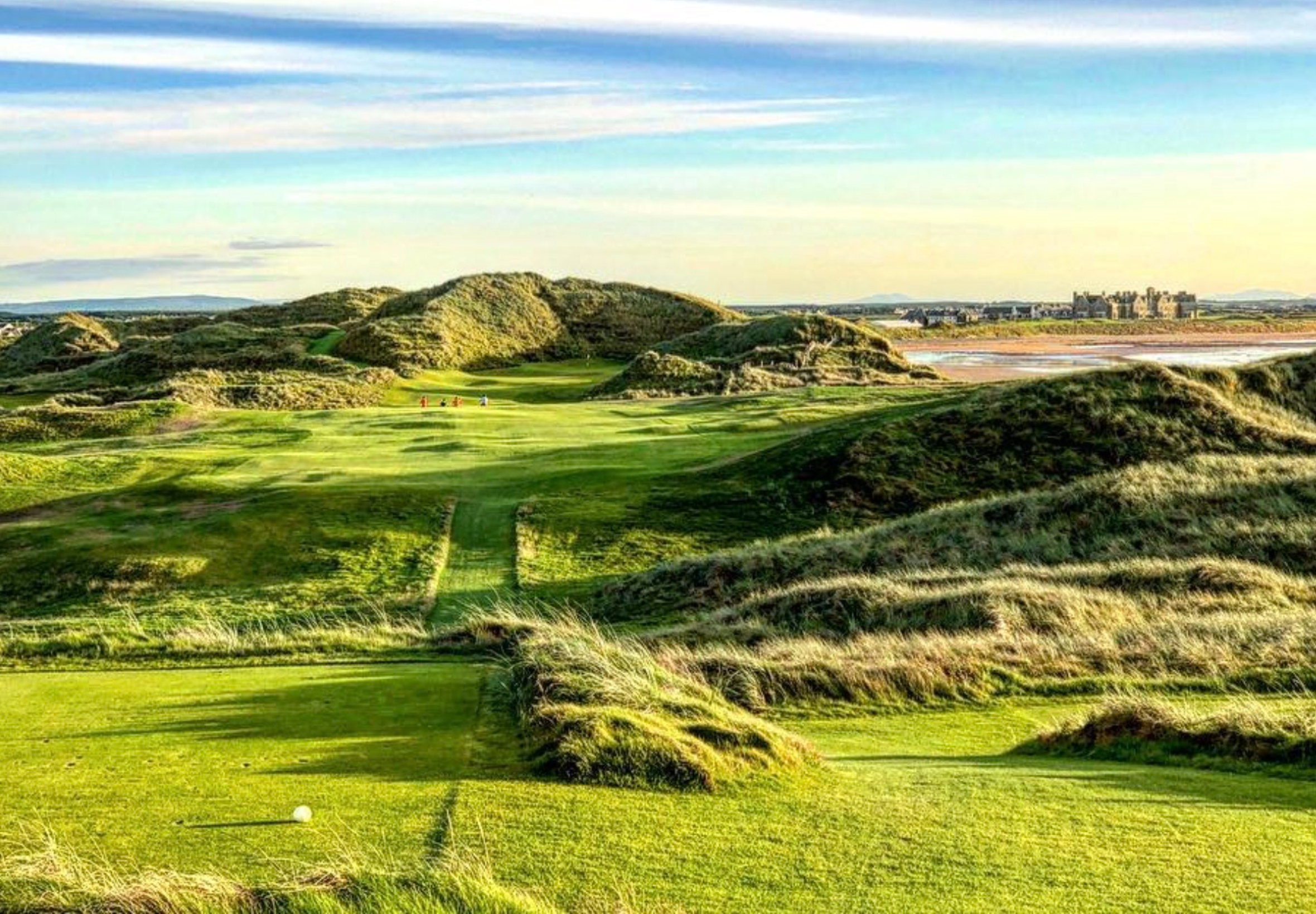 Scenic golf course with rolling green hills.