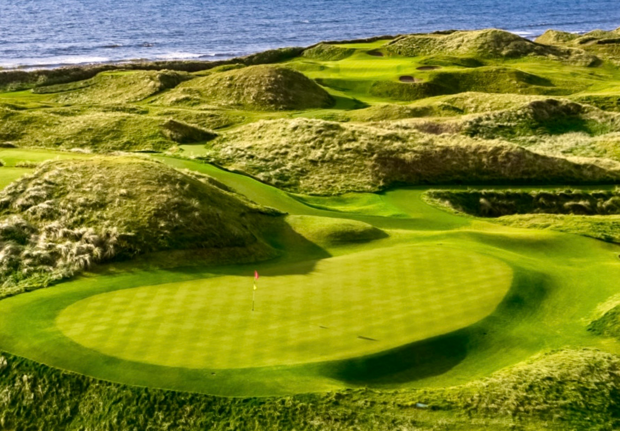 Coastal golf course with lush green fairways.